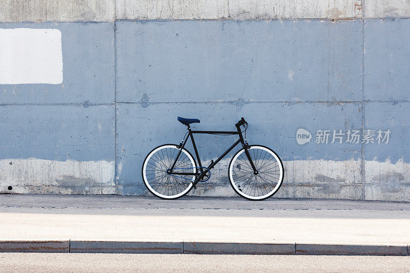 City bicycle against concrete background